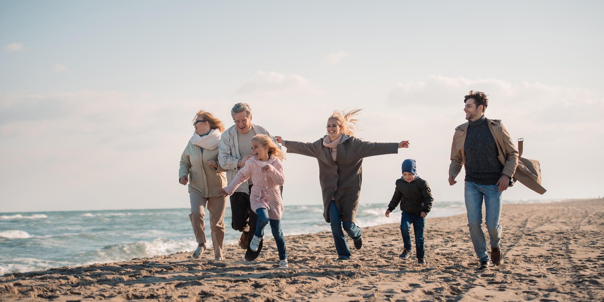 family-walking-on-beach
